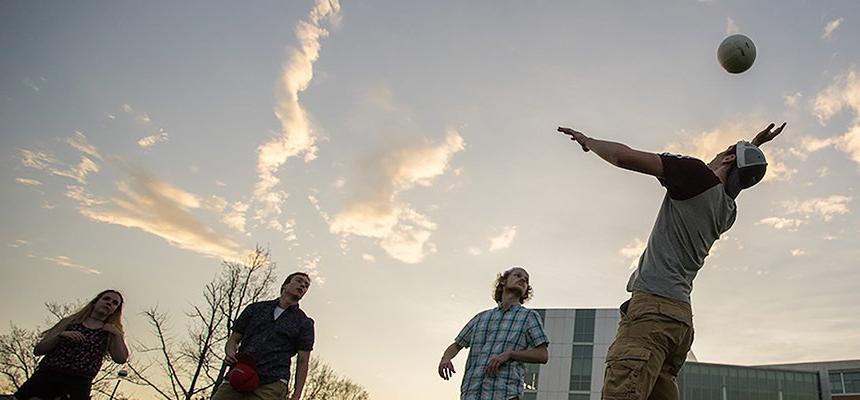 Students playing volleyball.